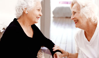 2 women smiling at each other
