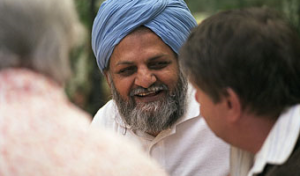 man smiling at someone else in foreground